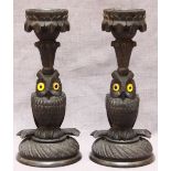 A pair of 19th century Irish Carved Bog Oak Candlesticks, each modelled as an owl supporting