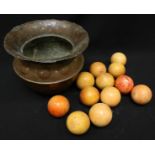 Twelve 19th century ivory billiard balls, with traces of original colour, in a copper jardinière