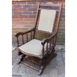 An early 20th century stained beechwood American rocking chair (for restoration)