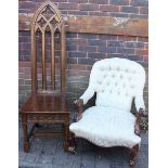 A Victorian walnut armchair, with a deep button back and floral, cream upholstery, scrolling arms,