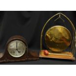 An Edwardian mahogany and brass dinner gong, and a 1930s oak mantle clock. (2)
