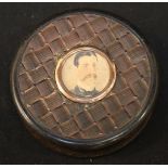 A 19th century tortoiseshell circular pill box, the lid inset with a small watercolour portrait of a