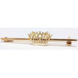 A 9ct gold bar brooch with seed pearl set crown, total approx. weight 2.9grms.