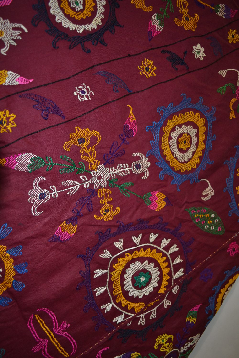 Uzbek suzani, deep plum cotton ground embroidered in bright silks with all over design worked - Image 8 of 8
