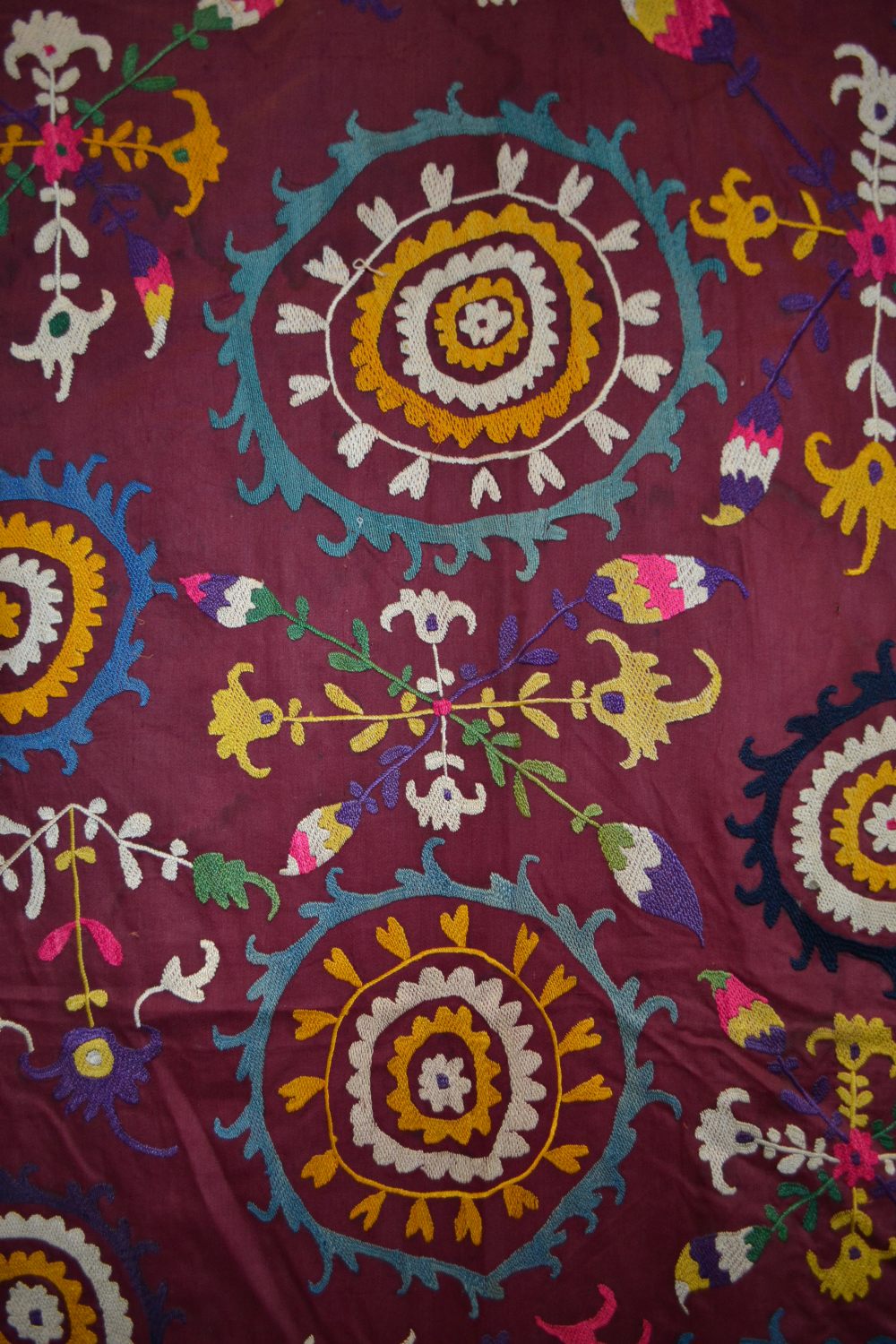 Uzbek suzani, deep plum cotton ground embroidered in bright silks with all over design worked - Image 6 of 8