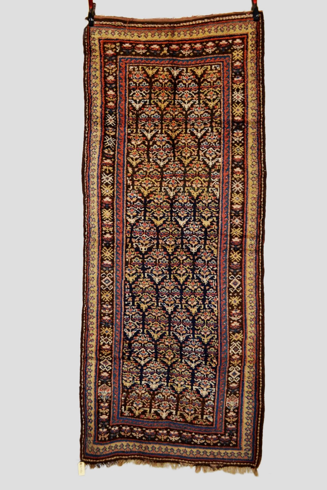 Kurdish long rug, north west Persia, about 1930s, 8ft. 1in. x 3ft. 4in. 2.46m. x 1.02m.