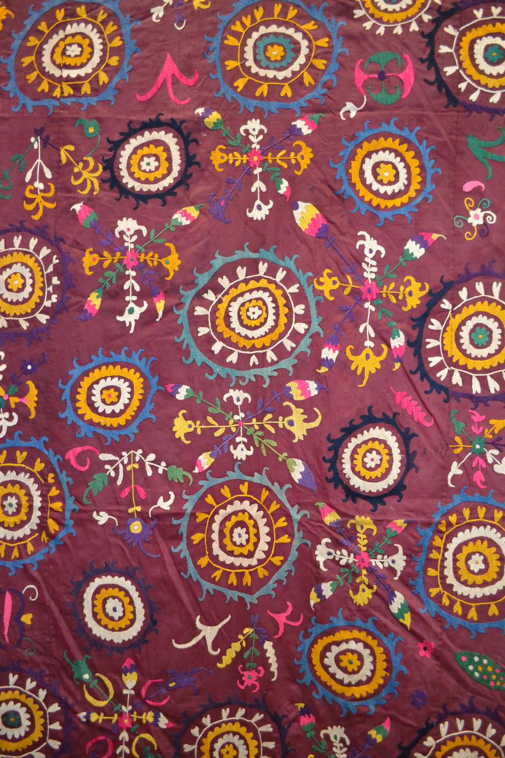Uzbek suzani, deep plum cotton ground embroidered in bright silks with all over design worked - Image 2 of 8
