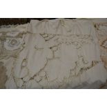 Collection of textiles comprising a cutwork and white embroidered undyed cotton window drape, worked