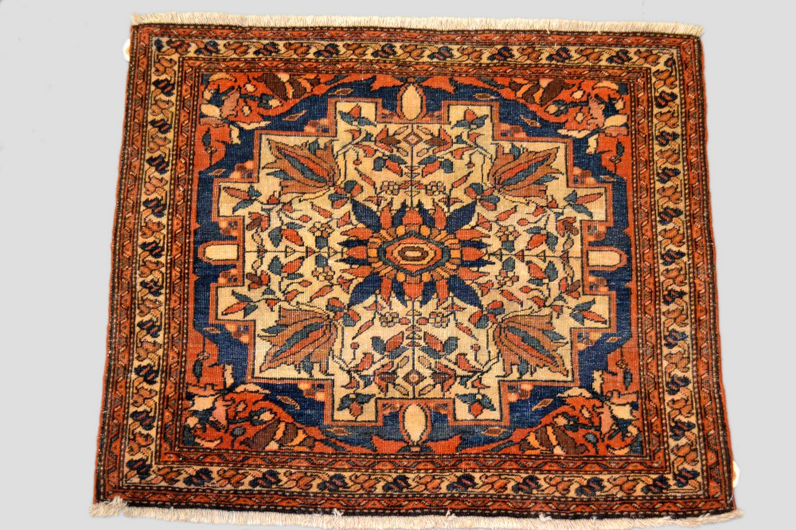Saruk mat, Feraghan area, north west Persia, early 20th century, 2ft. x 2ft. 5in. 0.61m. x 0.74m.