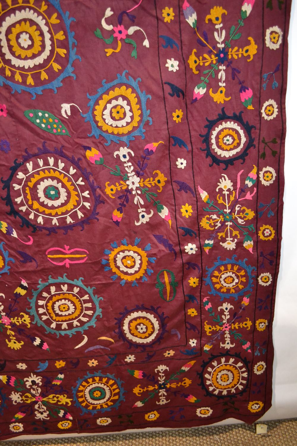 Uzbek suzani, deep plum cotton ground embroidered in bright silks with all over design worked - Image 4 of 8