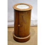 A Victorian mahogany circular pillar pot cupboard, the marble inset top above a door reveals a