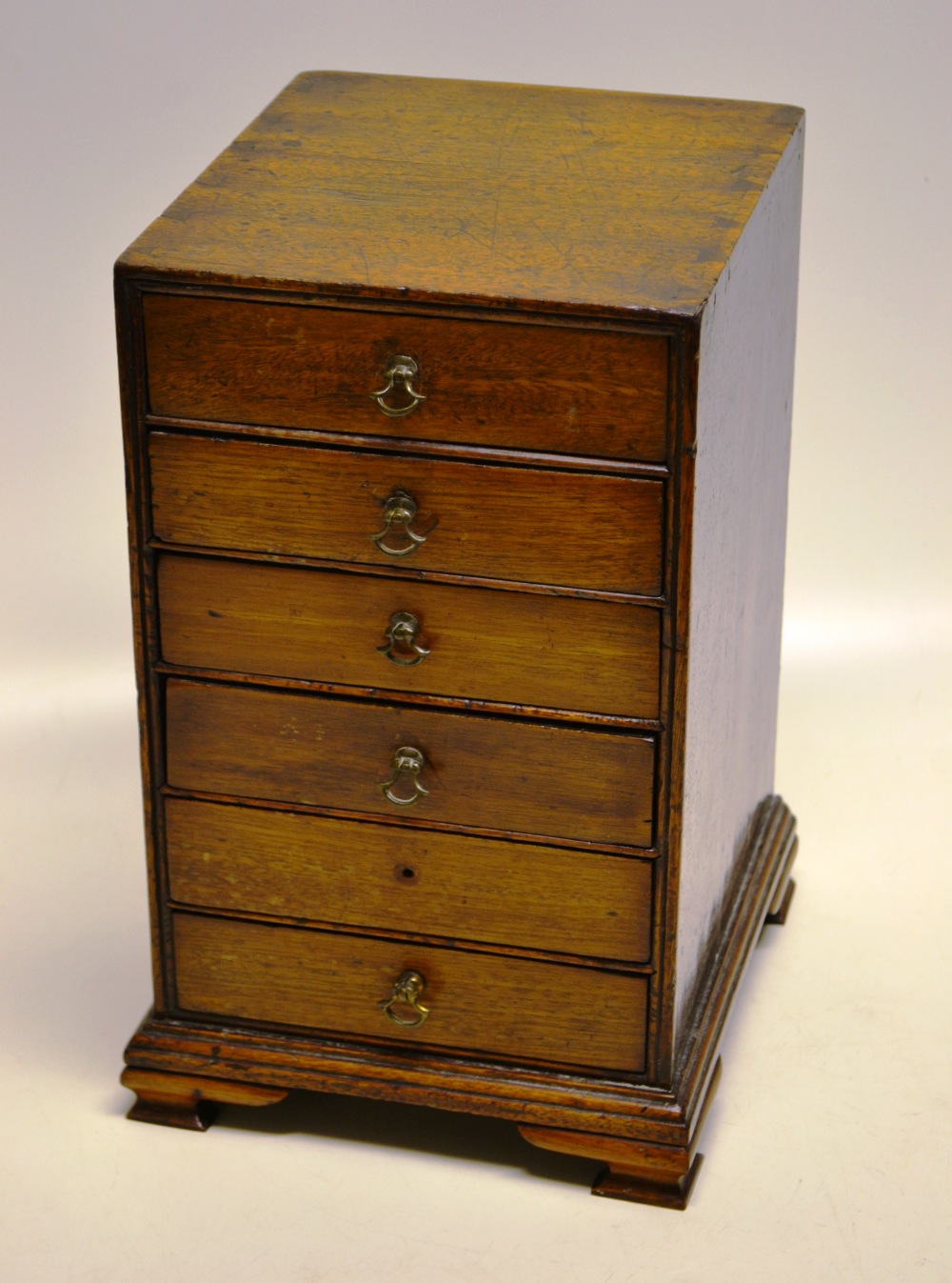A late eighteenth century small mahogany nest of drawers table cabinet, of six oak lined drawers