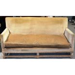 A three seater settee, upholstered in fawn dralon with a cushion seat on material covered legs,