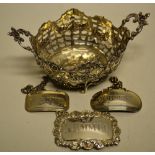 A late Victorian Continental oval pierced silver bonbon basket, chased with floral swags, two chased