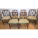 A set of six Sheraton provincial style mahogany dining chairs, the reeded cross frame backs