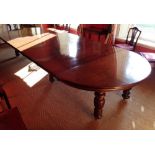 A large Victorian walnut extending dining table, the half round ends with extra leaves (some