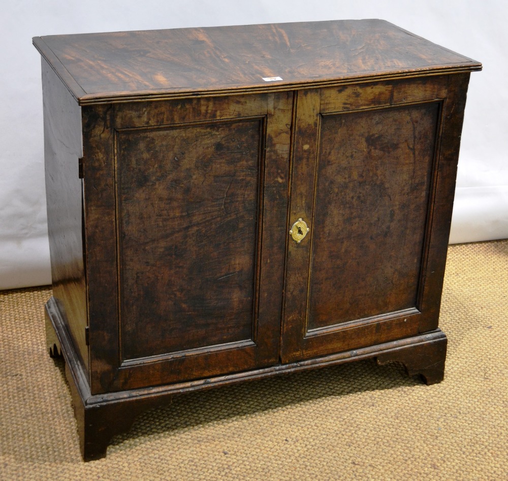 A mid eighteenth century elm press cupboard, the later applied reeded edge to the top, above sliding