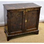 A mid eighteenth century elm press cupboard, the later applied reeded edge to the top, above sliding