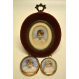 Two late Victorian oval miniatures on ivory, The Currie children, in glazed gold and gilt frames and