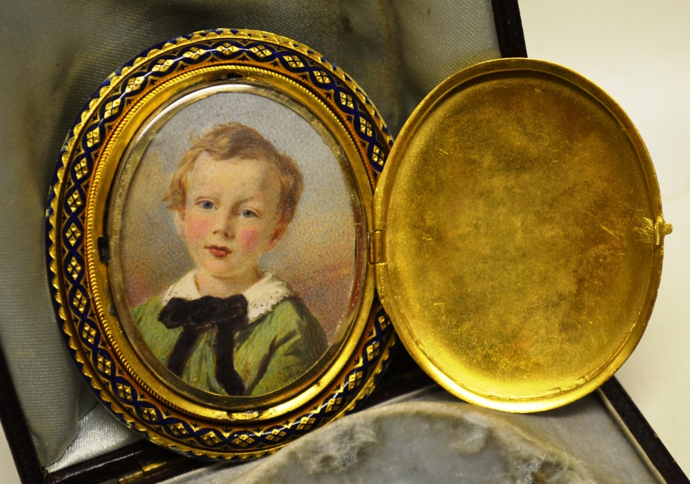 A Victorian gold brooch/pendant oval with blue enamel decoration, having a hinged locket at front