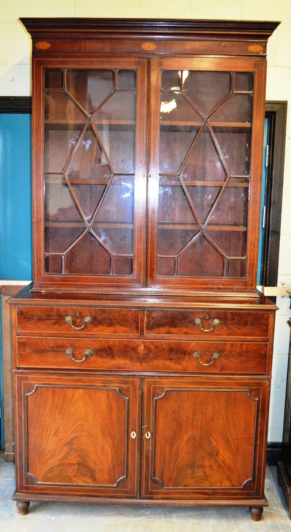 A nineteenth century mahogany library bookcase, inlaid chequer stringing, the top with a