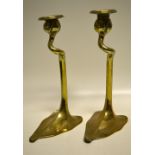 A pair of Art Nouveau brass candlesticks, the tendril stems with bud candleholders, detachable