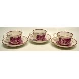 Three china cups and saucers A set of three Victorian china cups and saucers, transfer puce