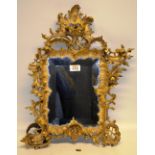 A nineteenth century Italian carved rococo giltwood frame boudoir mirror, with a bevelled