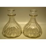 A pair of Victorian glass ship's decanters, panel cut sides, star cut bases and stoppers.
