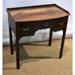 A late nineteenth century Sheraton Revival mahogany bow fronted dressing table, the top with a