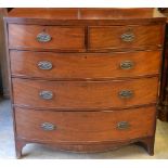 An early nineteenth century figured mahogany veneered bow front chest, the top edged with stringing,