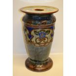 An Edwardian Doulton stoneware jardinière stand, decorated in brown, blue and green with raised