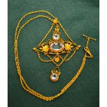 An Edwardian gold pendant necklace, set with three aquamarines in an Etruscan style setting, with
