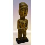 A central African carved wood ceremonial female figure, with numerous rings to the neck, (the