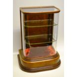A late Victorian walnut table display cabinet, the 'D' shape glass front with two glass shelves,