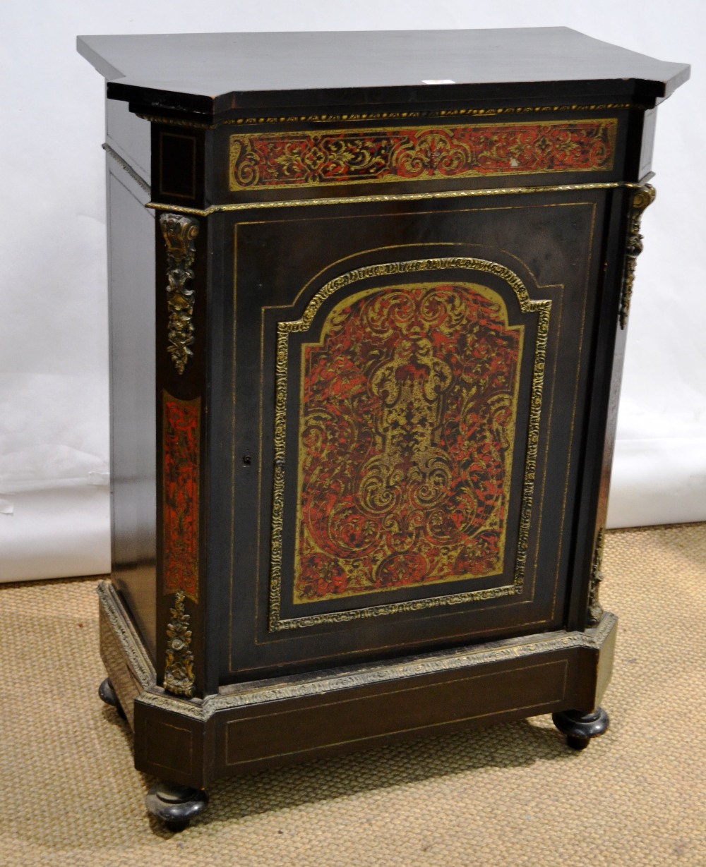 A nineteenth century French Pier cabinet, ebonized wood with brass stringing and chased ormolu