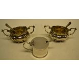 A pair of Edwardian ogee partly moulded salts, with glass liners and scrolling handles and two