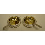 A pair of George III circular cast trencher salts in late seventeenth century style, having