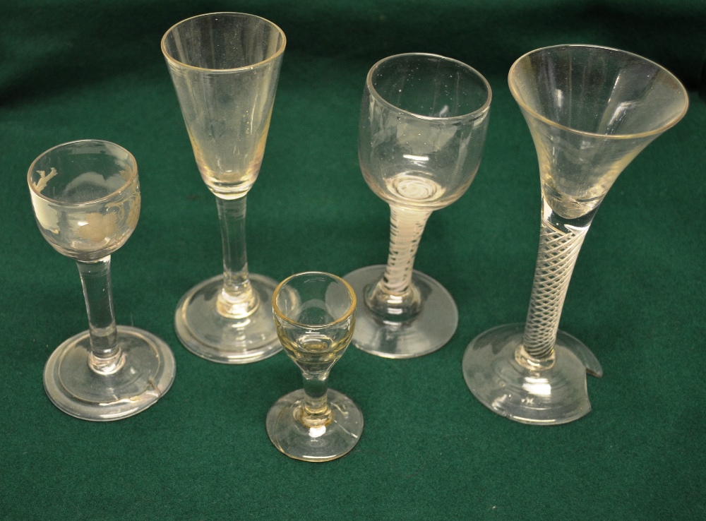 An eighteenth century trumpet bowl wine glass on a folded foot 7in (18cm), a mid eighteenth