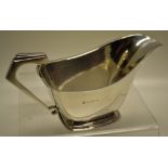 A pair of Art Deco design silver sauce boats, the rectangular bodies with stepped bracket handles,