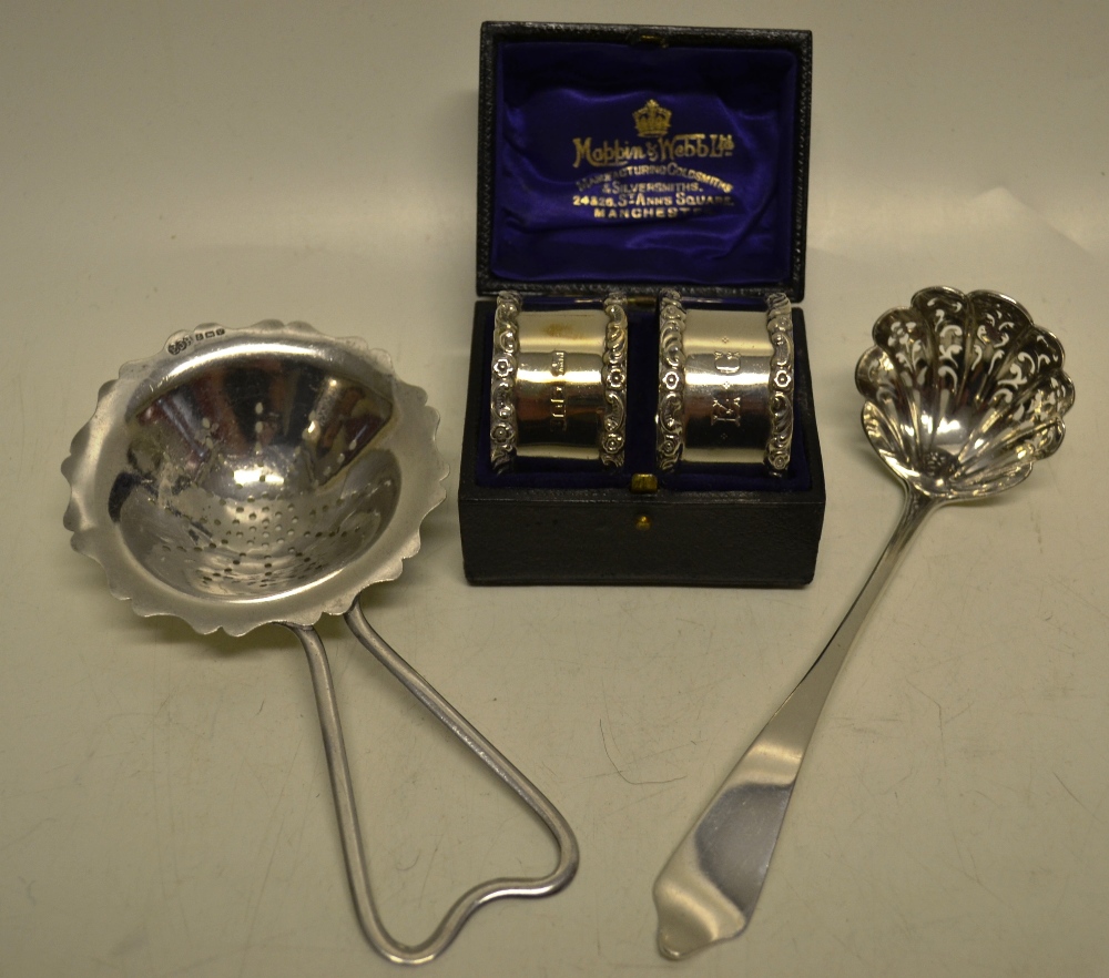 A Victorian silver sifter ladle with dognose terminal, a silver tea strainer and a pair of Edwardian