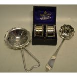 A Victorian silver sifter ladle with dognose terminal, a silver tea strainer and a pair of Edwardian