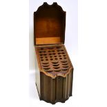 A Sheraton mahogany knife box, the sloping lid with flame veneer, reveals a fitted interior, the