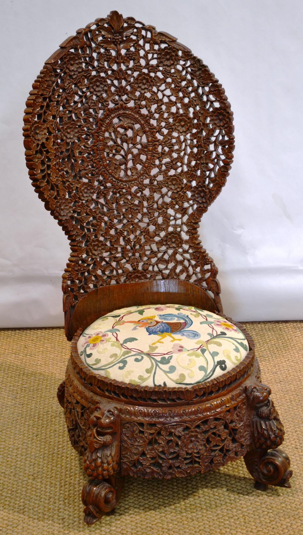 An Indian Bombay Presidency nineteenth century high back chair, with profusely pierced carved