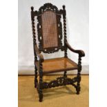 A walnut armchair, carved in William and Mary style with a Ducal crown crest to a high caned back,