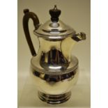 A silver coffee bigin, the baluster body with laurel leaf girdle moulding, a scroll spout and fine