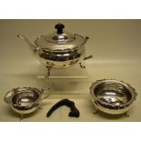 A George V silver compressed circular three piece tea service, with moulded borders, the teapot with