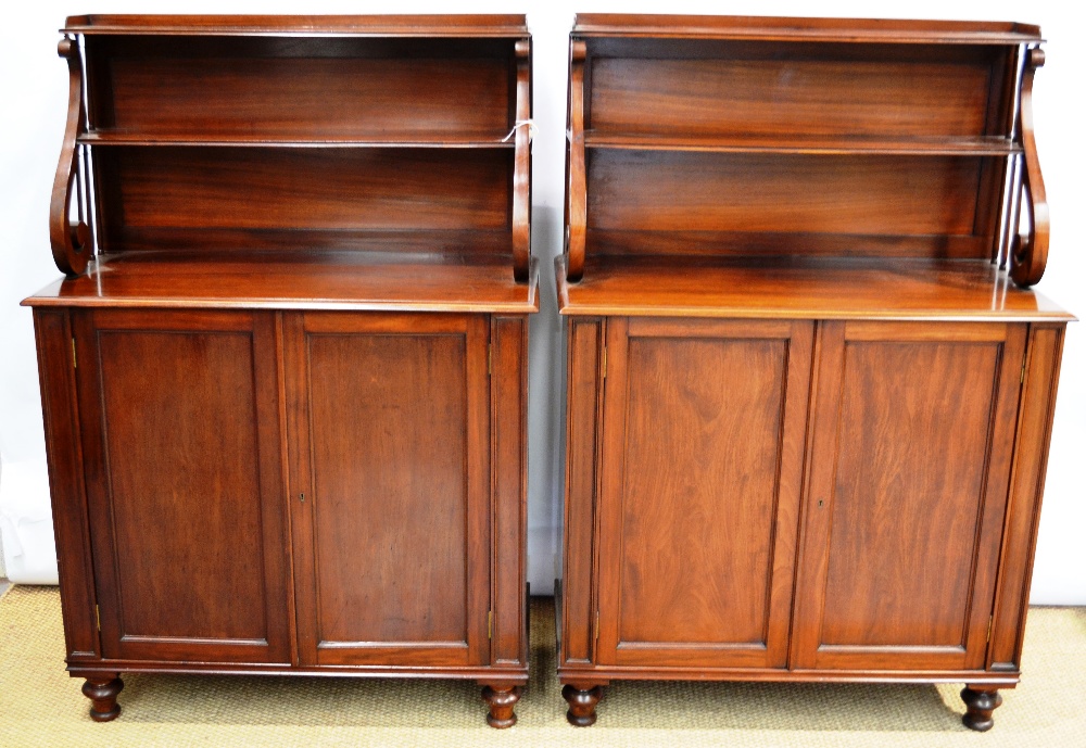 A pair of William IV mahogany chiffoniers, the raised panelled backs, with a top galleried shelf and