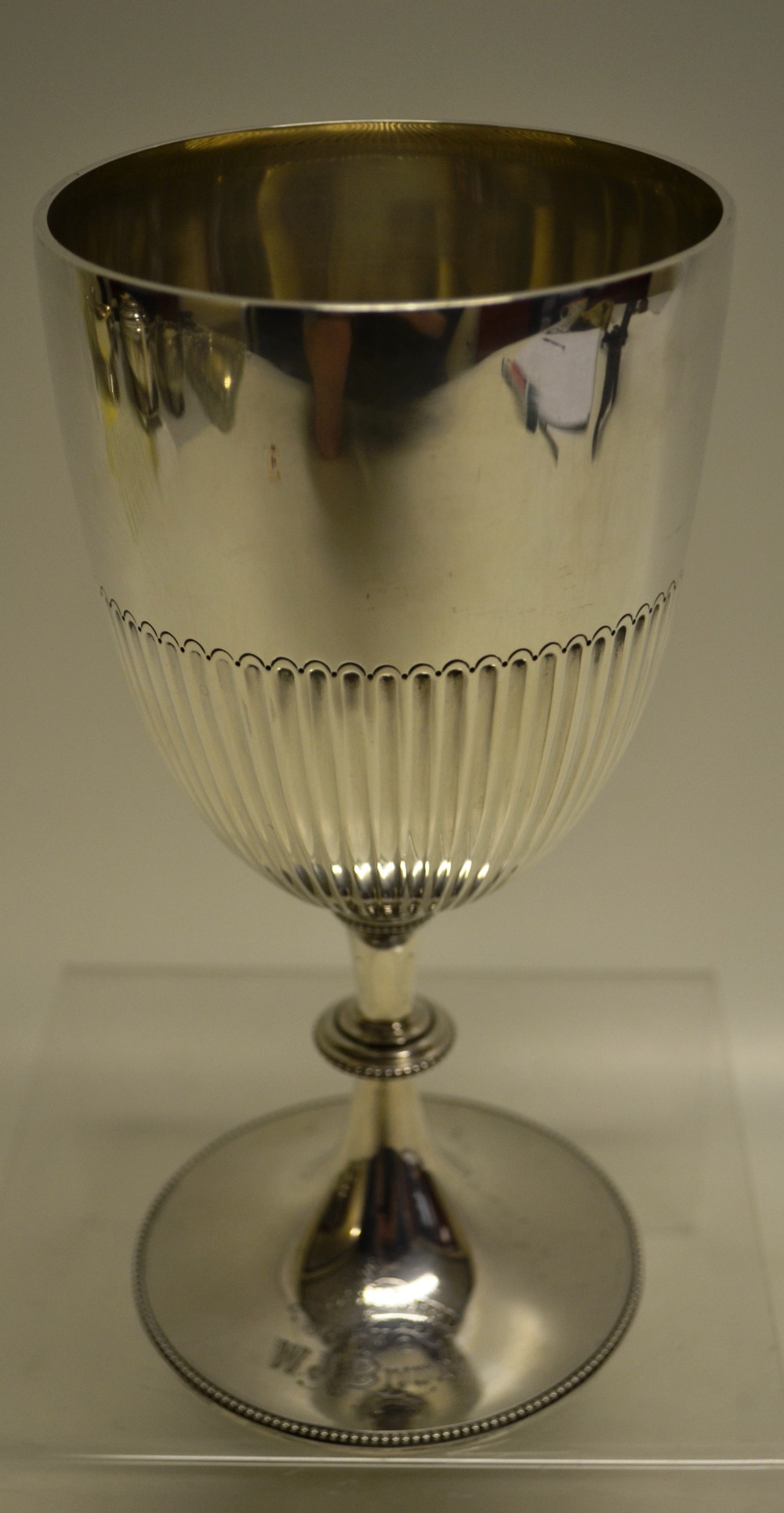 A Victorian silver cup, the bowl part fluted on a beaded edge knopped pedestal foot, with a