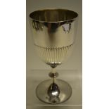 A Victorian silver cup, the bowl part fluted on a beaded edge knopped pedestal foot, with a